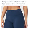 A close-up of a navy blue high-waist yoga legging worn by a person, highlighting the smooth front panel design.