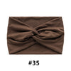 A dark brown fabric headband tied in a knot, shown flat lay.