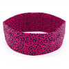 A women's sports headband featuring a vibrant pink and black leopard print pattern.