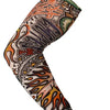 A close-up of a long seamless tattoo sleeve featuring intricate orange, black, and gray tribal designs on skin.