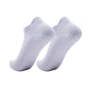 A pair of white women's yoga and fitness socks shown from above.