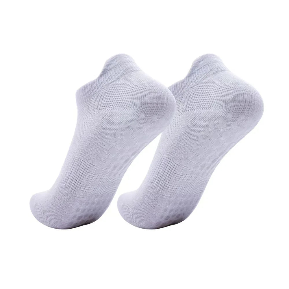 A pair of white women's yoga and fitness socks shown from above.