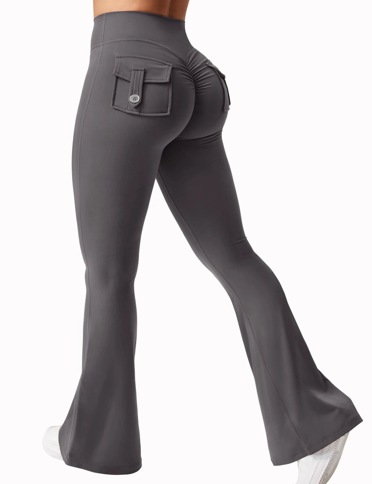 A woman wearing gray high stretch yoga leggings with a front pocket and a side seam detail.