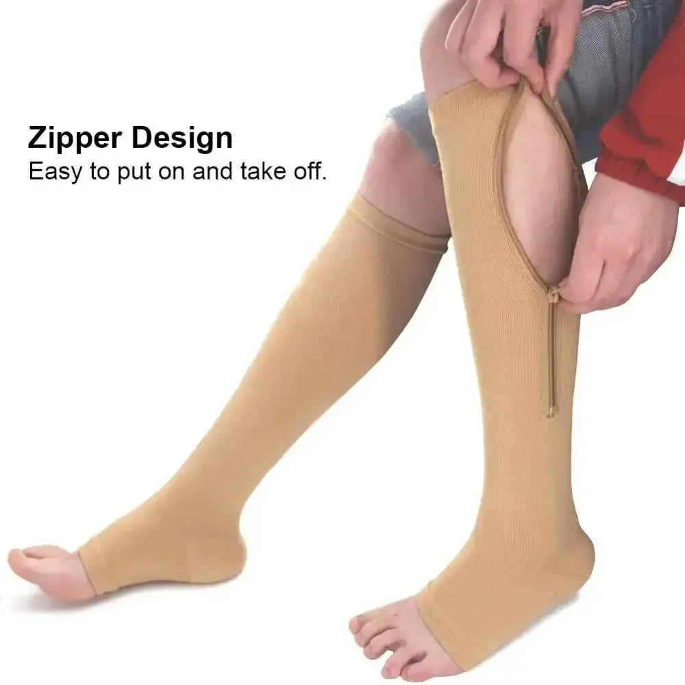 A close-up of beige compression stockings with a zipper design being put on a person's leg.