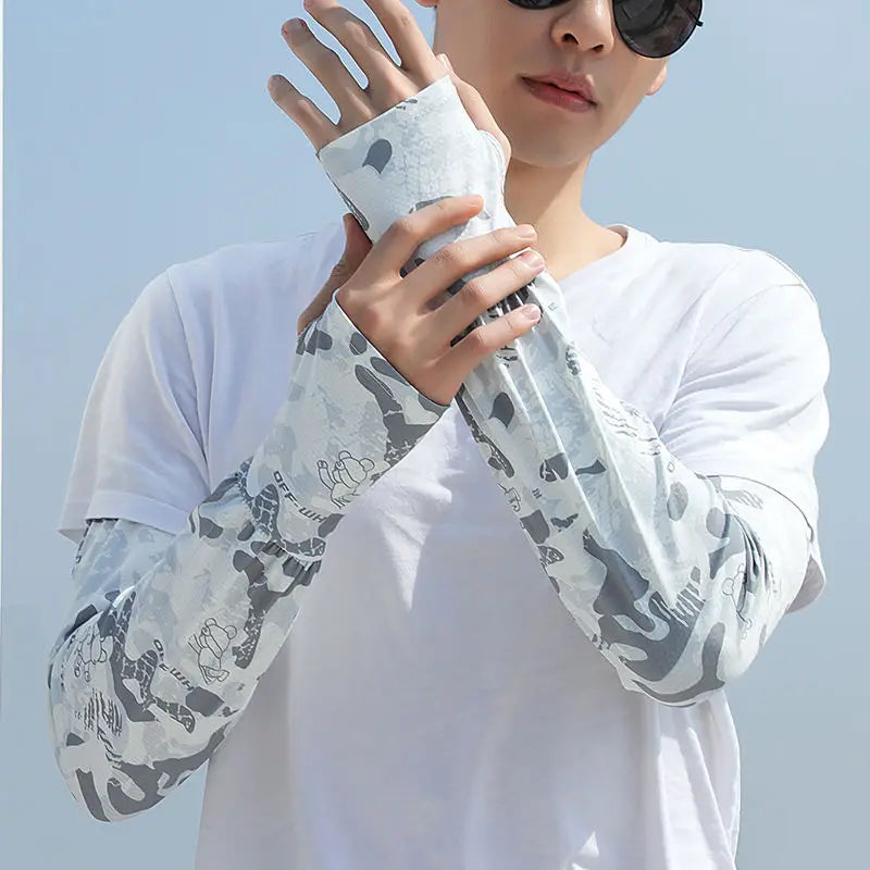 Person in white clothing models loose arm sleeves with a camouflage pattern for UV protection.