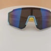 A pair of dark sunglasses with blue mirrored lenses and light blue frames resting on a white surface.