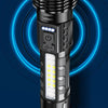 A close-up view of a black tactical LED flashlight with an illuminated front and blue glowing rings in the background.