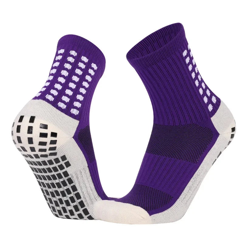 Purple and white performance sports grip socks shown from the side.