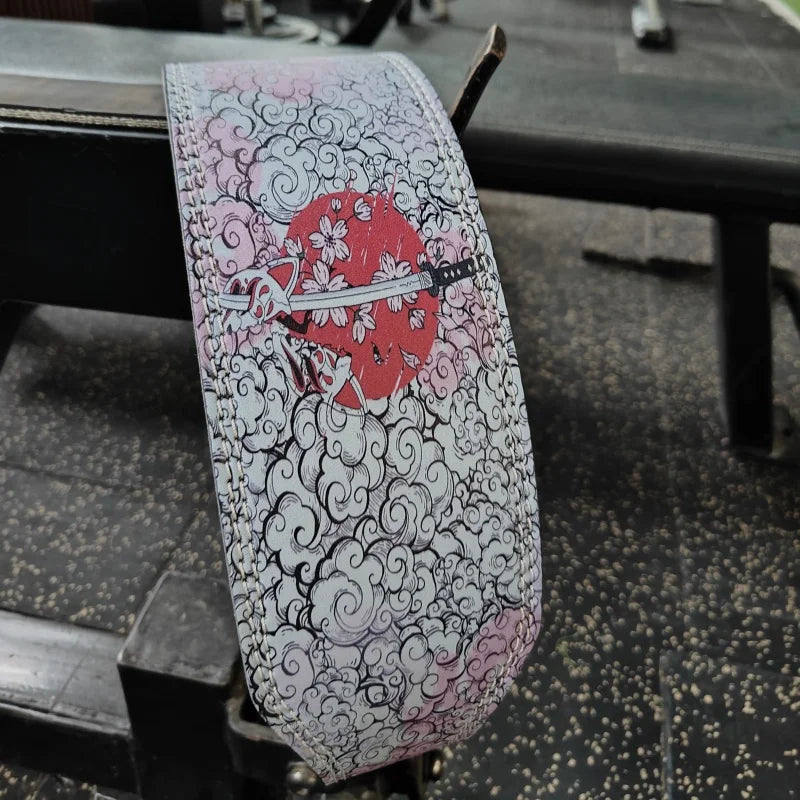 A weightlifting belt featuring a design of a red flower and swirling black and pink patterns.