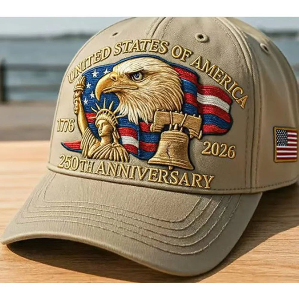 A beige adjustable baseball cap featuring a gold embroidered eagle over an American flag design for the 250th anniversary.