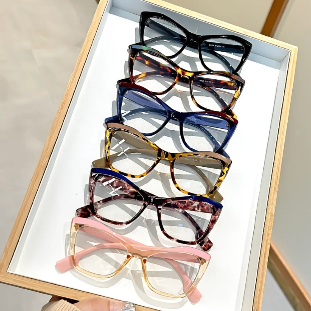 A display of vintage color block blue light blocking eyewear in a wooden frame.