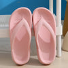 A pair of pink comfort platform flip flops resting on a white surface.