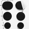 A collection of black self-adhesive shoe repair patches of varying sizes, including circular and triangular shapes.