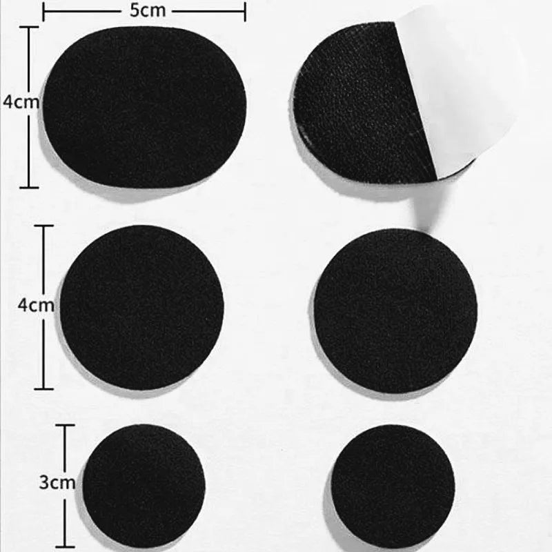 A collection of black self-adhesive shoe repair patches of varying sizes, including circular and triangular shapes.