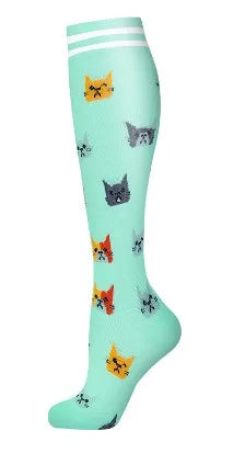 Light green compression socks featuring small cat face patterns.