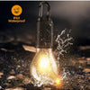 A black IP65 waterproof LED camping lantern illuminates a surface with water splashes.