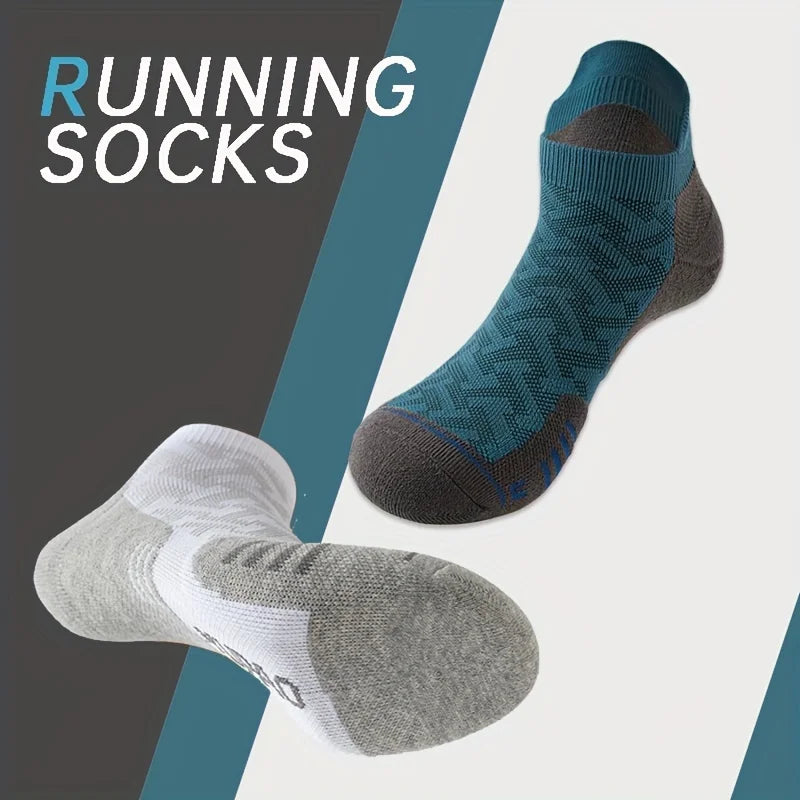 A pair of blue and gray performance ankle socks are shown against a dark background.