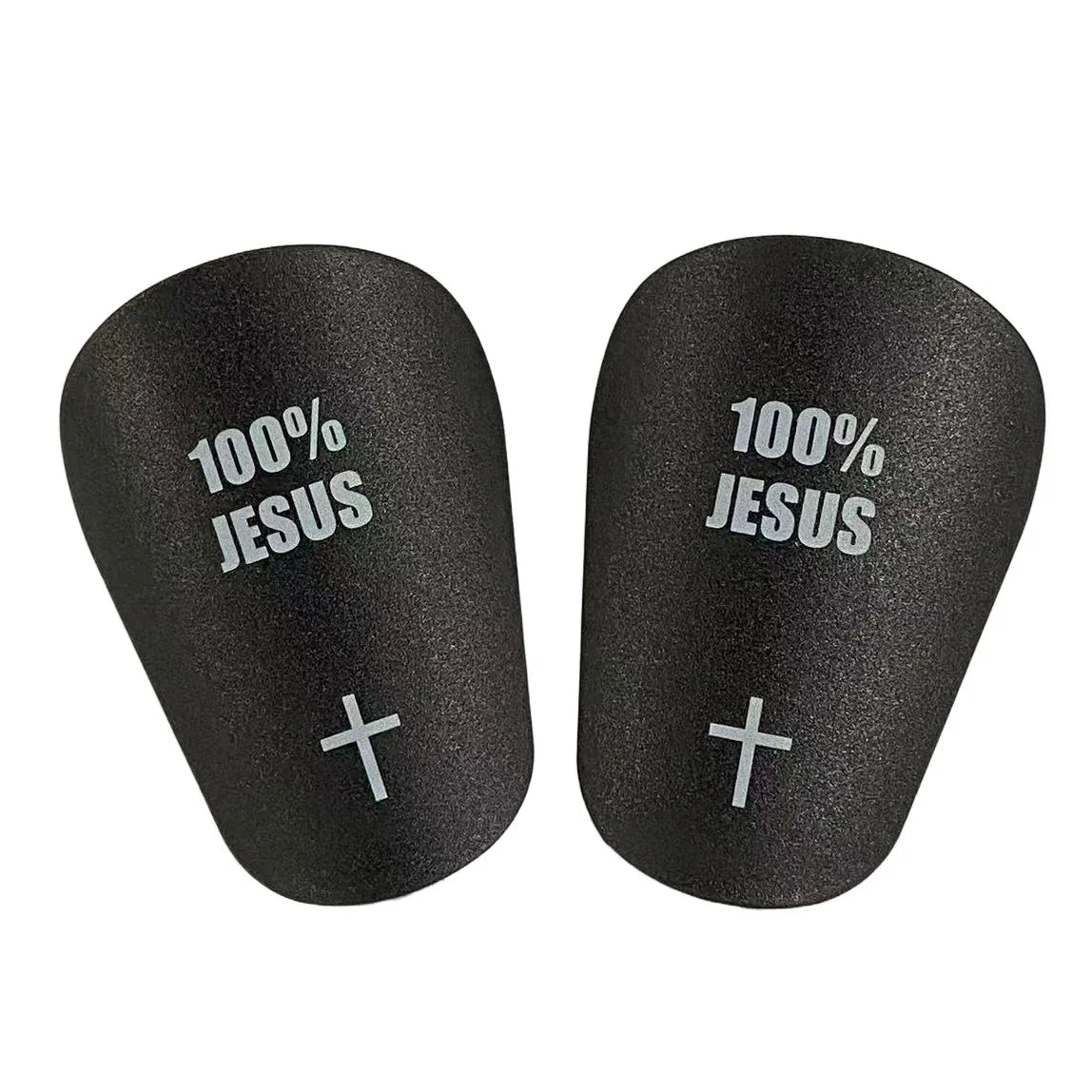 A pair of black lightweight soccer shin guards with 100% Jesus printed on them.