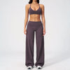A woman wearing a dark purple women's premium fitness tracksuit top and pants.