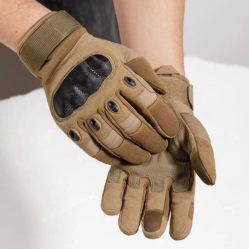 A close-up of tactical full finger gloves in olive green leather with a black mesh palm, worn on a hand.