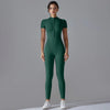 A model wearing a dark green Naked Zipper Yoga Jumpsuit standing against a plain gray background.