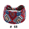 A patterned boho cotton turban headband featuring red, blue, and white geometric designs.