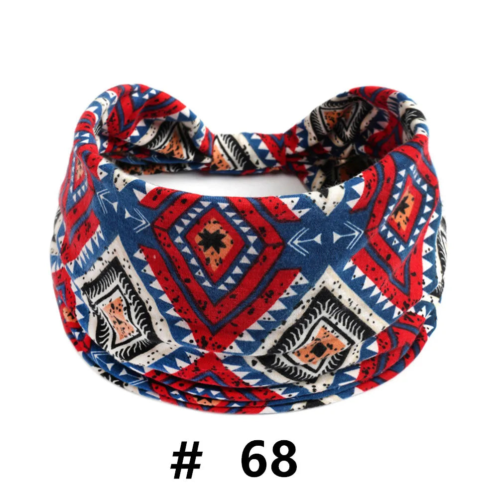 A patterned boho cotton turban headband featuring red, blue, and white geometric designs.