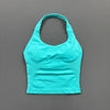 A bright turquoise seamless performance yoga and gym tank top displayed against a gray background.