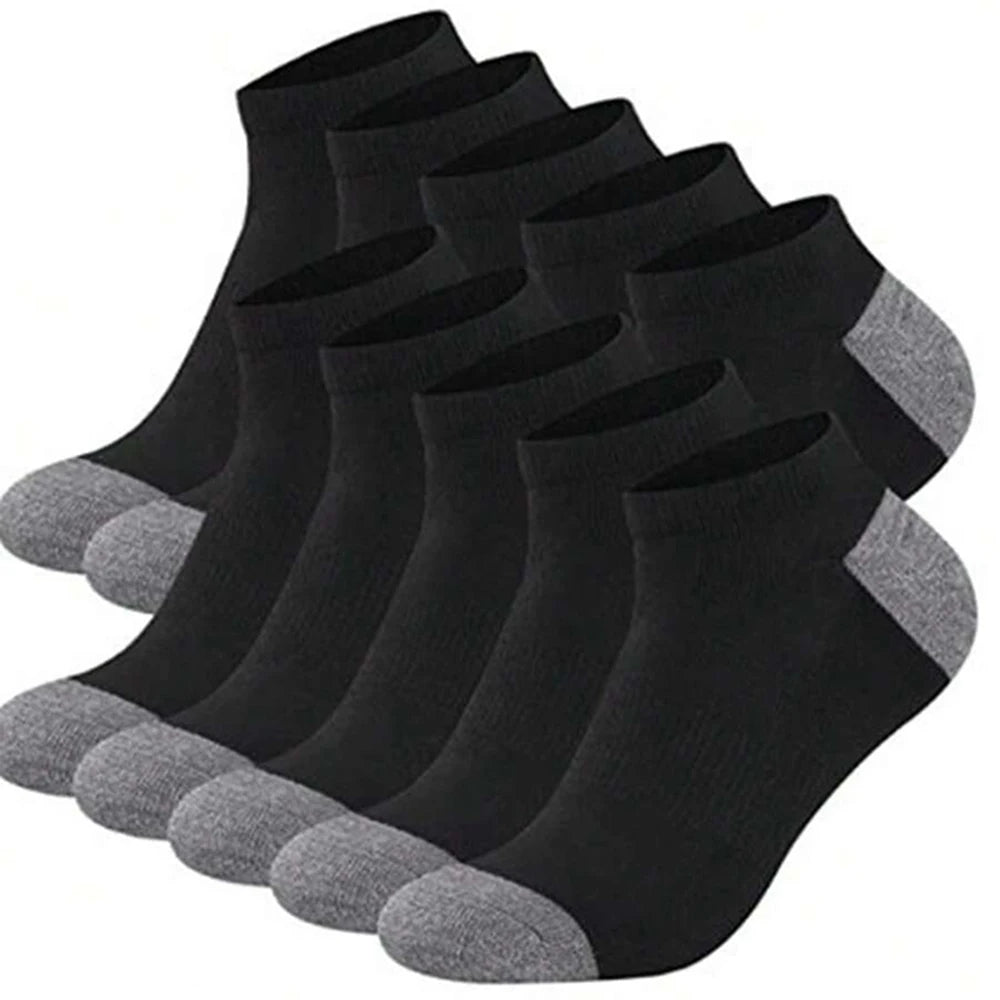A stack of ten black and gray ankle socks laid out for display.