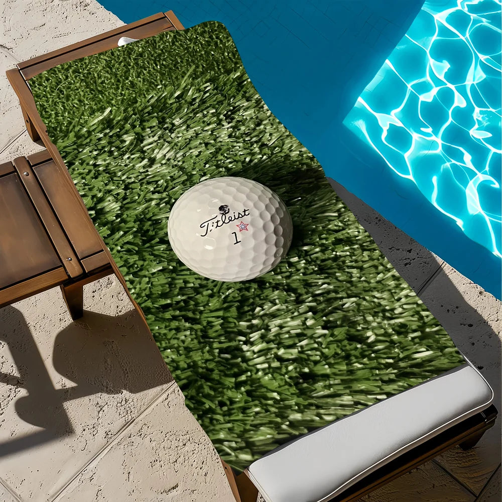 A bright green microfiber beach towel is laid out on a wooden deck next to a blue swimming pool.