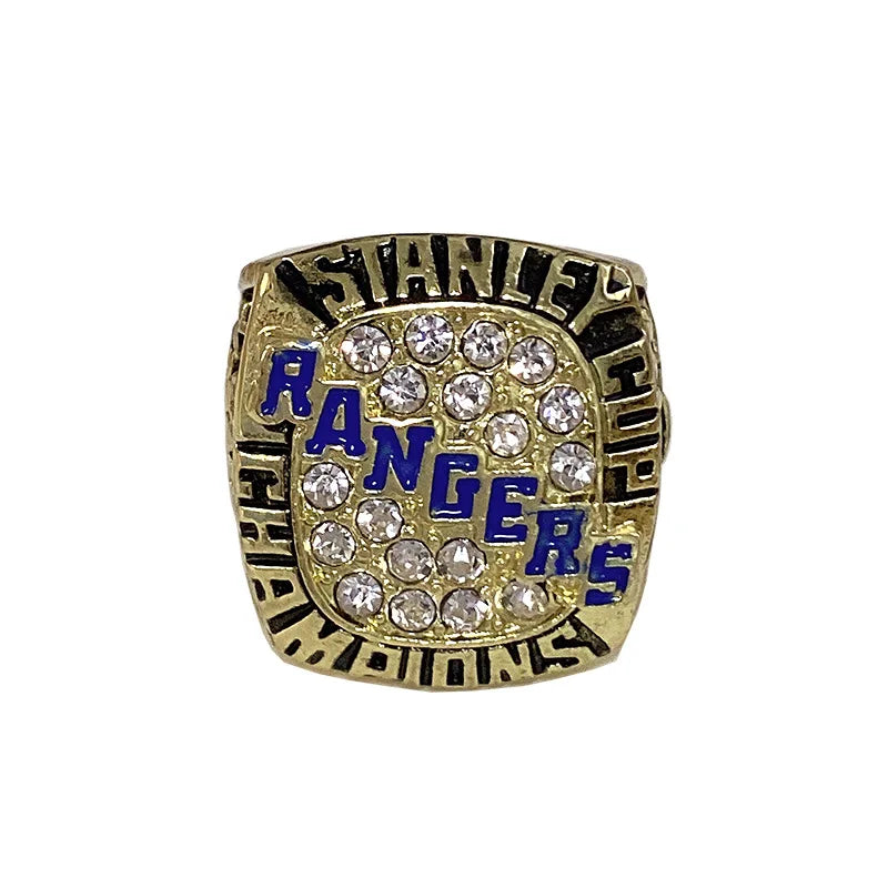A gold ring featuring the Stanley Rangers logo surrounded by clear diamonds.