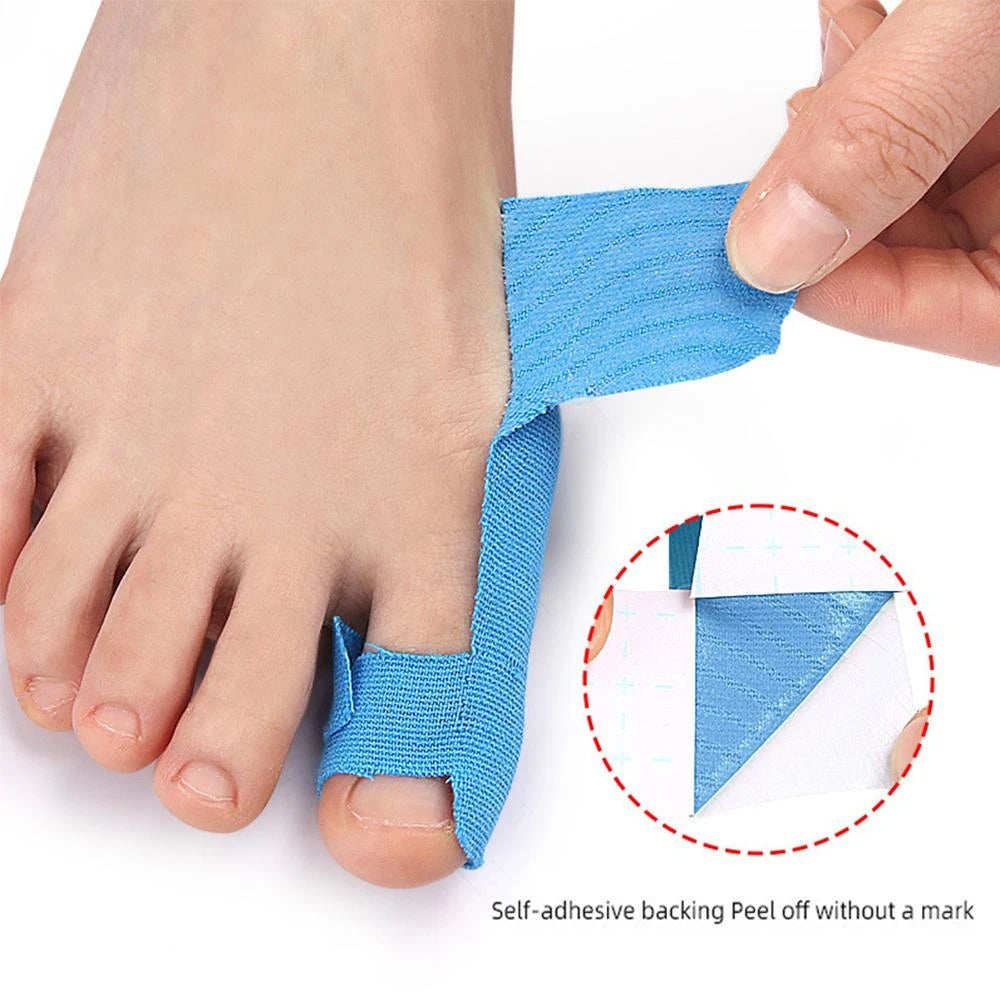 Blue self-adhesive peel off tape being applied to a foot for bunion and toe support