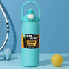 A light blue insulated stainless steel water bottle with a green lid standing on a light blue surface.