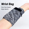 A black and white striped wrist bag is shown on a person's arm, demonstrating its use for sports.