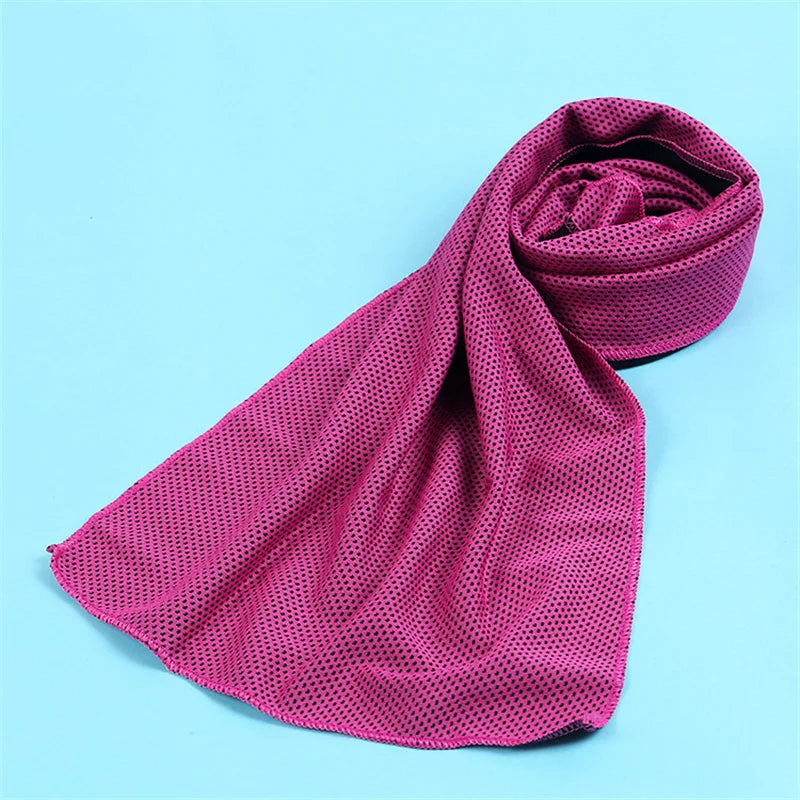 A magenta microfiber cooling towel is rolled and displayed against a light blue background.