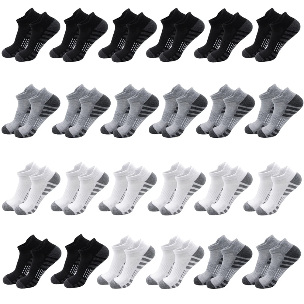 A row of black ankle athletic running socks for men and women laid out flat.