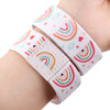 A pink and white stretch wristband bracelet featuring a rainbow pattern with hearts and stars.