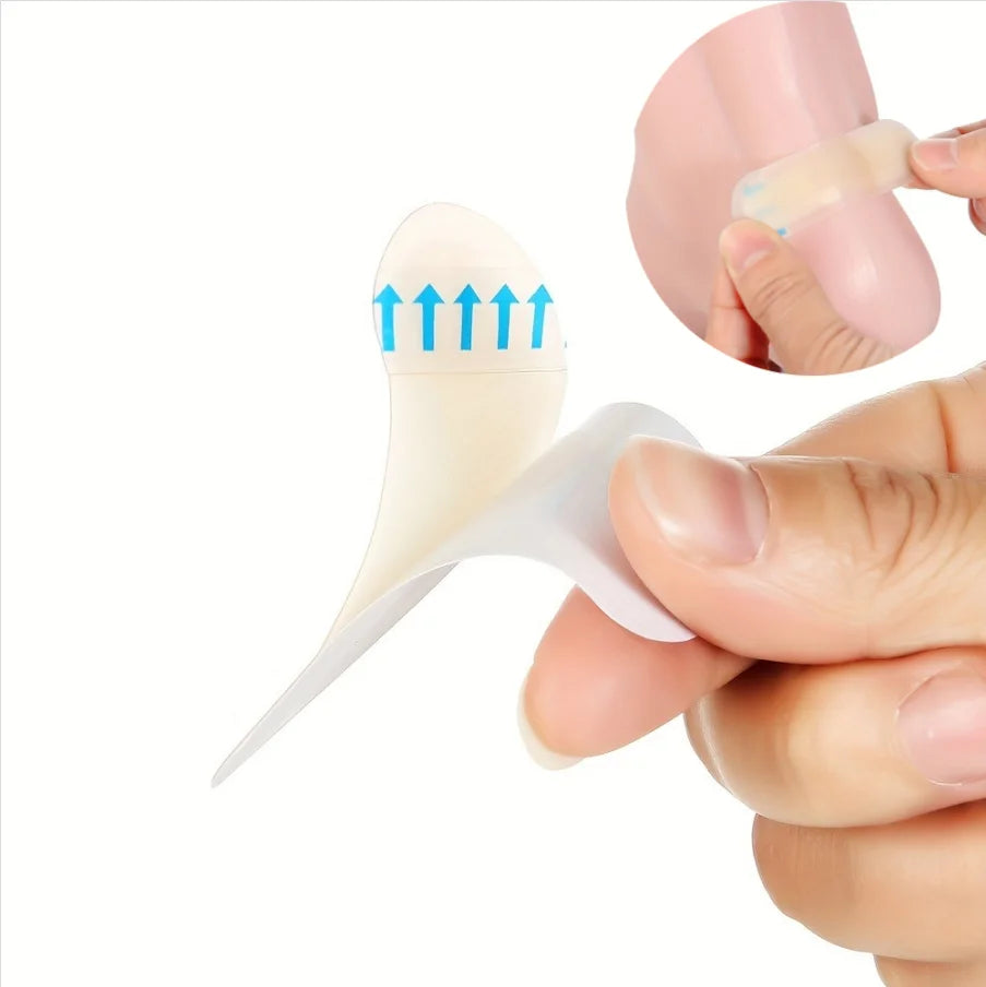 A hand is applying an invisible silicone blister patch to a foot, showing the product's shape and application.