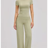 A woman models a moss green high-waist yoga and gym leggings set.