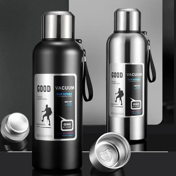 A black and silver insulated thermos bottle with a screw top and carrying loop is shown on a dark surface.