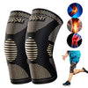 Black copper knee compression sleeve worn by a person exercising.