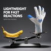 A pair of white goalkeeper gloves with blue accents is shown resting on a digital scale next to a banana.