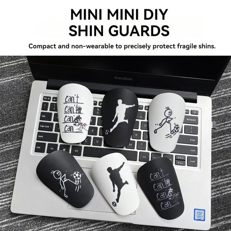 Mini DIY shin guards are shown resting on a laptop keyboard.
