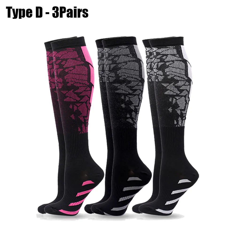 Three pairs of black compression socks with pink accents shown flat
