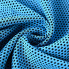 A close-up of a blue microfiber cooling towel fabric folded into a swirl with a black polka dot pattern.