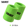 A pair of bright lime green knitted sport wristbands shown against a white background.