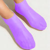 Purple silicone moisturizing socks shown on a foot.