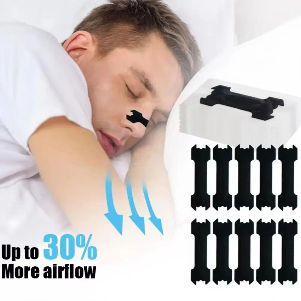 A person is applying black hypoallergenic nasal strips to their nose for congestion relief.