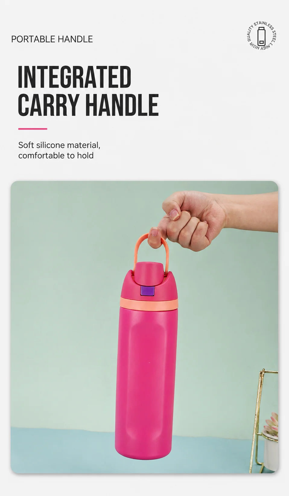 A hand is holding a bright pink insulated thermos mug with an integrated carry handle.