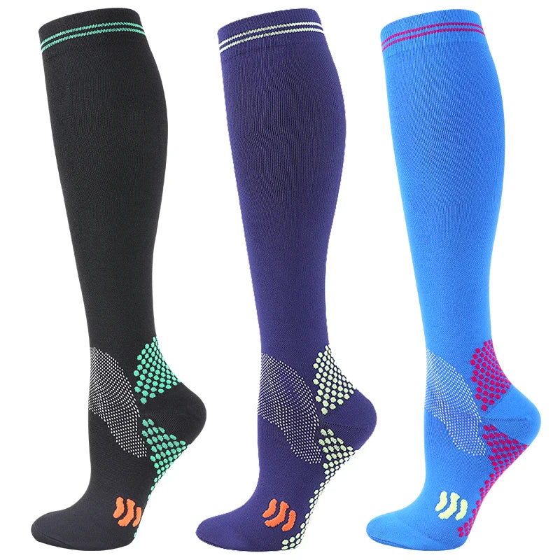 Three pairs of medical grade compression socks in black, navy blue, and bright blue.